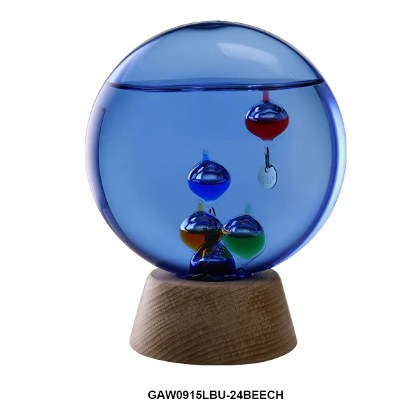 Blue glass Galileo thermometer on a wooden base