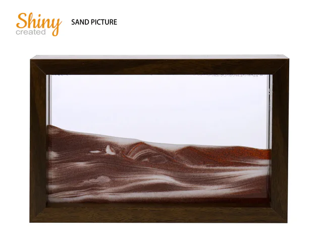 Framed sand picture with layered brown and white sand